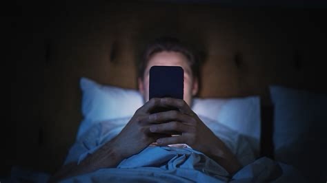 Person in bed on phone